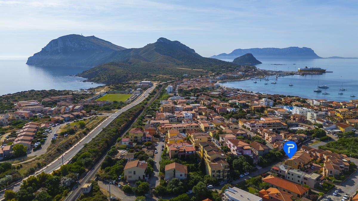 Aerial view of Golfo Aranci with Capo Figari, the island of Figarolo and the port, Gallura, north-east Sardinia
