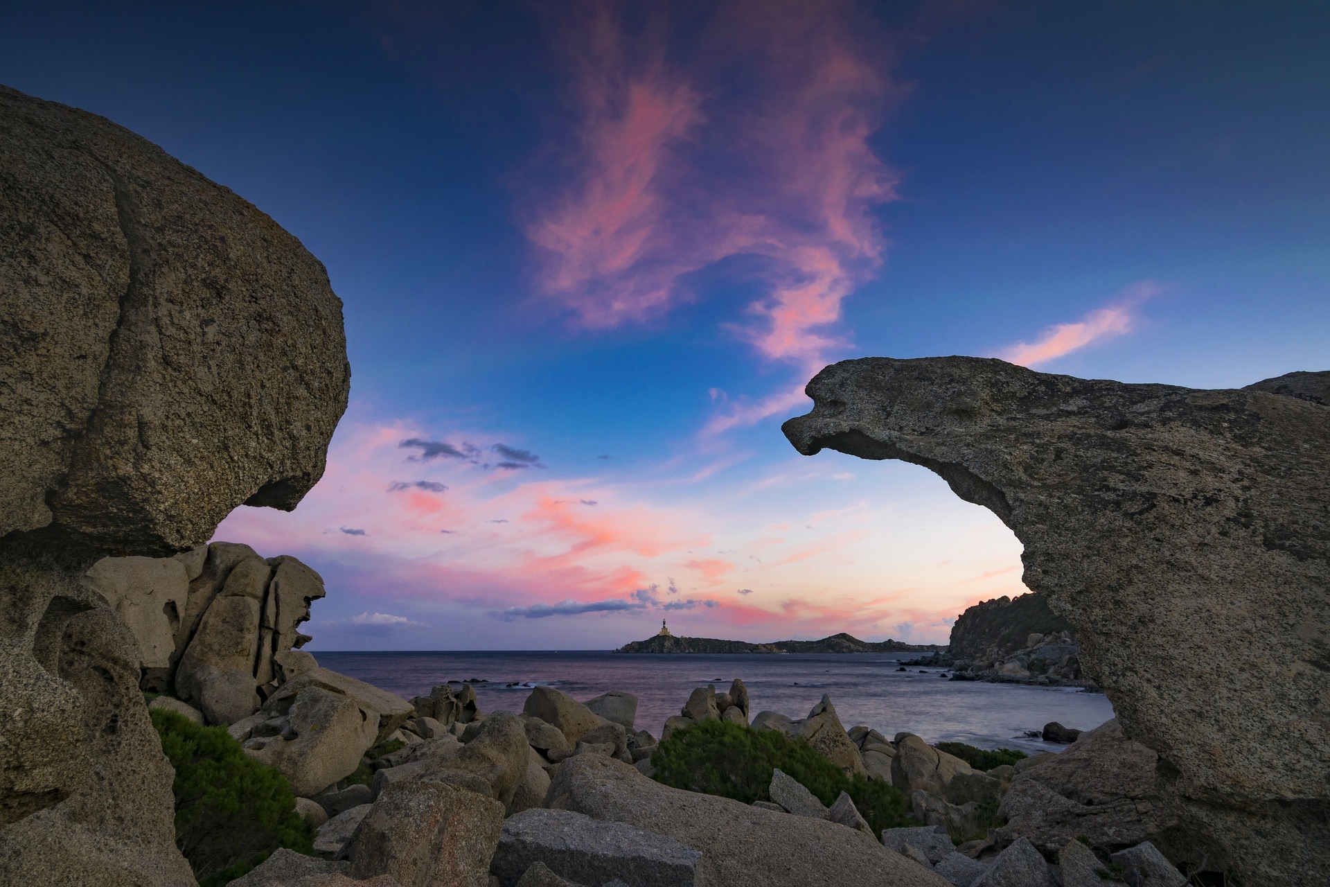 Sunset among the granite rocks at Cala Burroni with the Capo Carbonara lighthouse, Villasimius